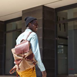 cheerful-handsome-dark-skinned-male-tourist-with-backpack-wearing-trendy-clothing-about-enter-modern-building-embassy-extend-visa-while-spending-summer-vacations-foreign-country (1)